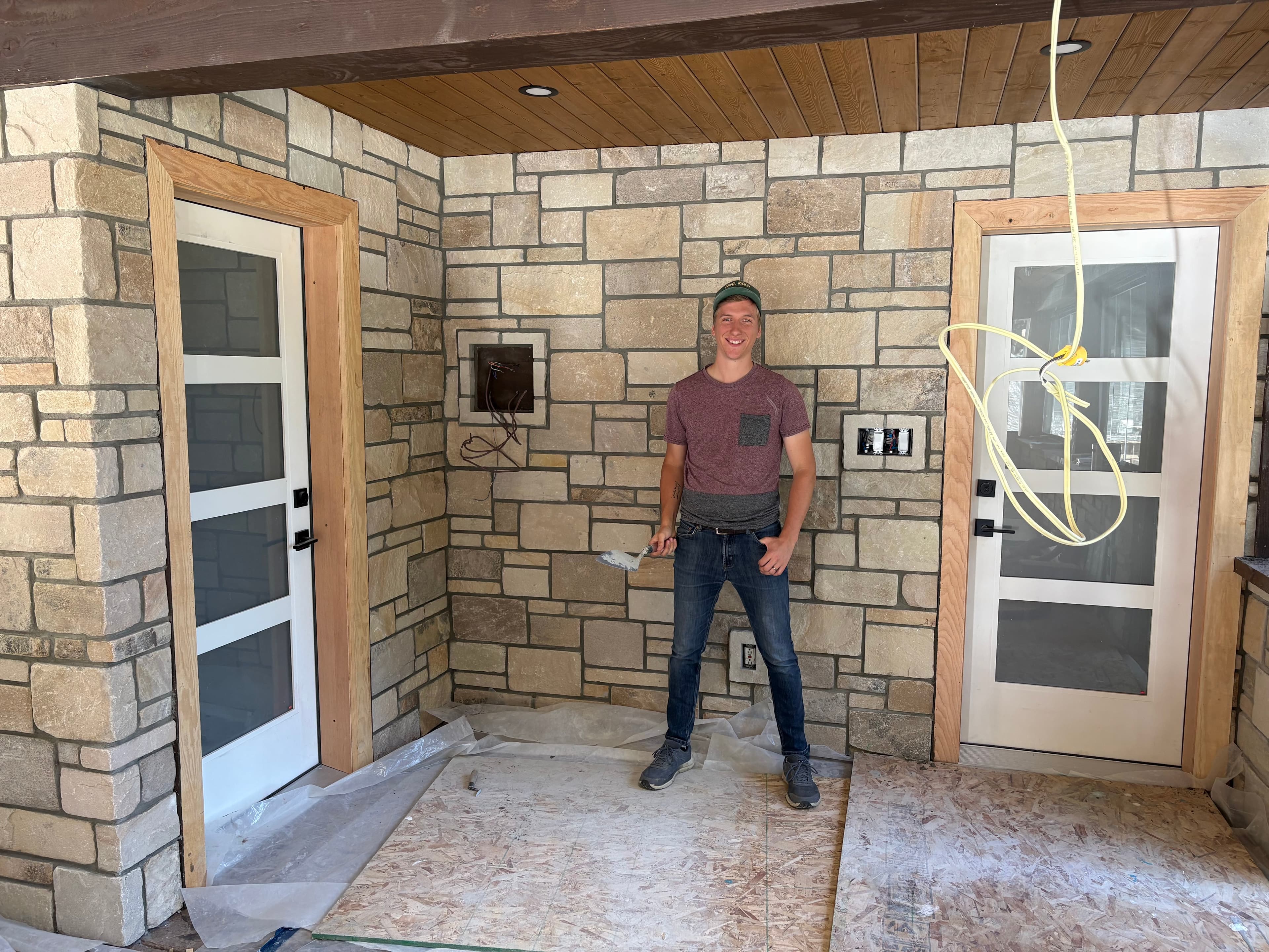 Cream stone veneer walls and columns in a covered porch breezeway