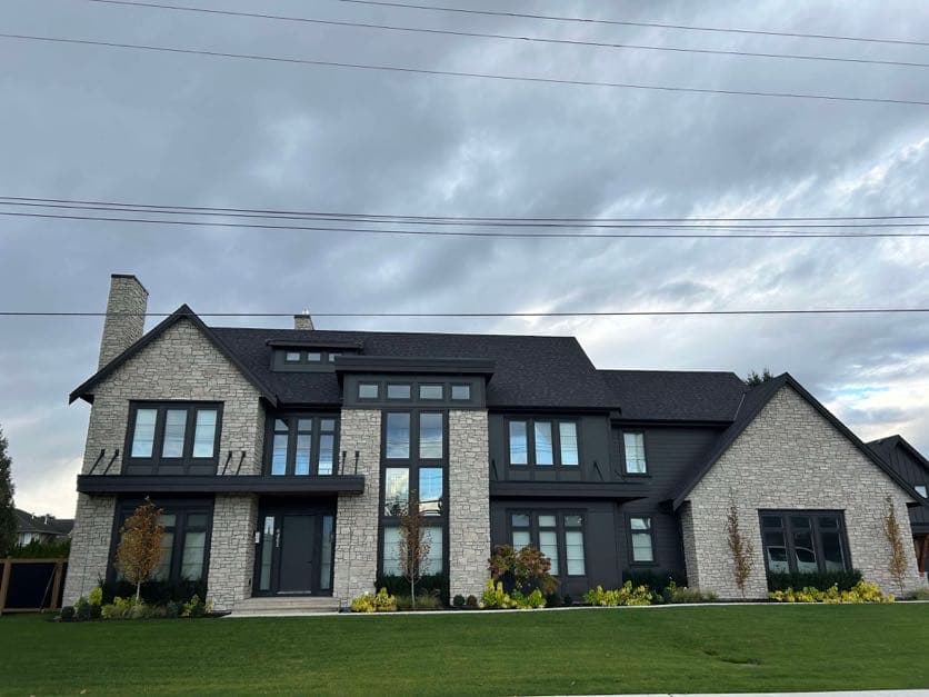 Natural stone veneer facade and chimney on a two-storey home exterior